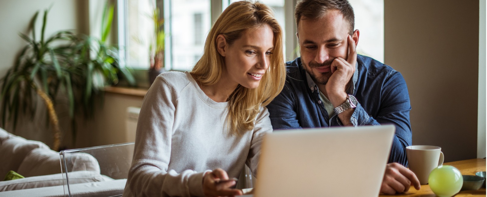 Woman and Man Looking at Laptop on Sunny Day