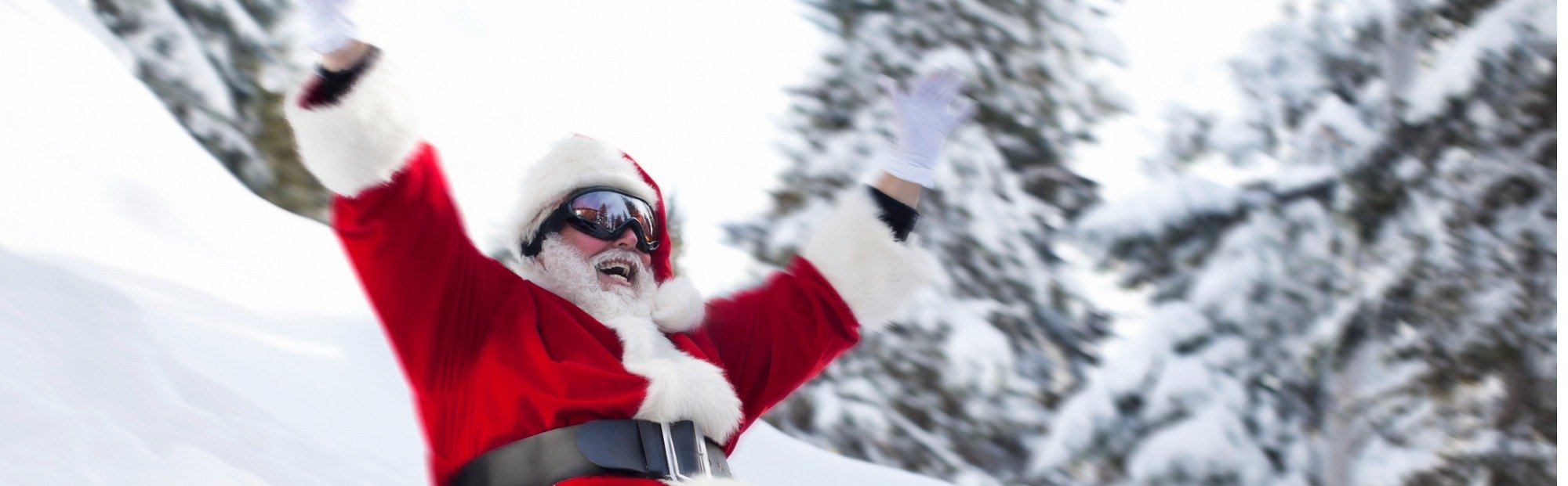 Happy Santa Claus Sliding Down Snowy Hill on Sunny Day