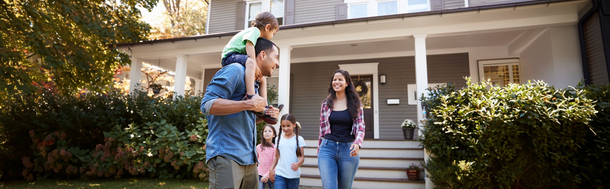 Smiling Family near Steps Outside House