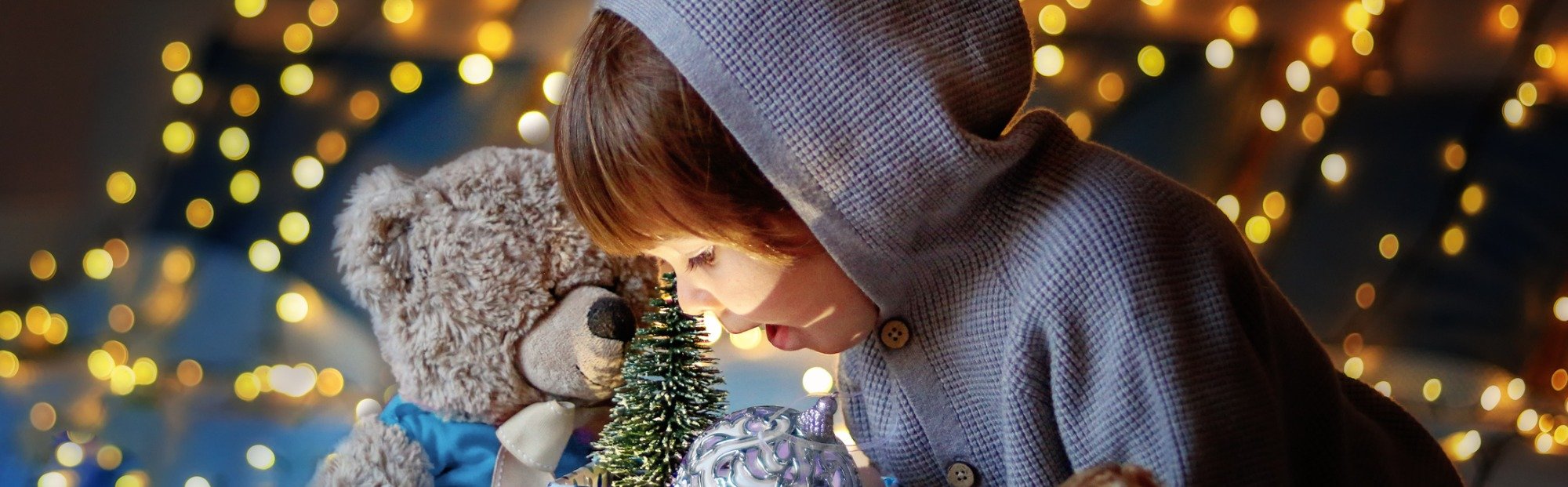 Little Boy Looking into Gift with Teddy Bear