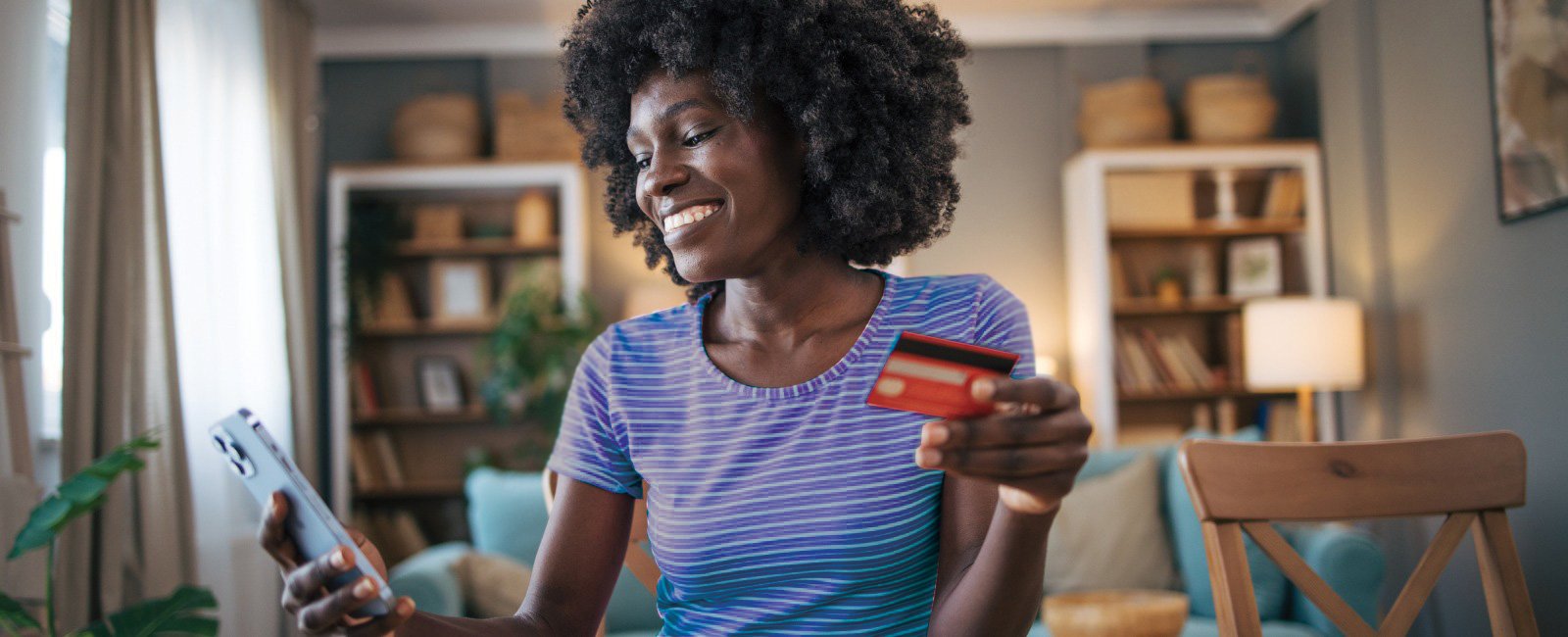 Credit Card image lady with blue shirt holding credit card